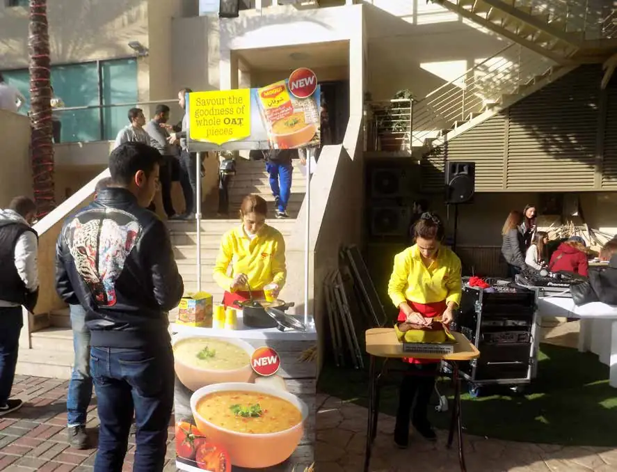 Maggi soup tasting stand with promoters cooking for passers-by