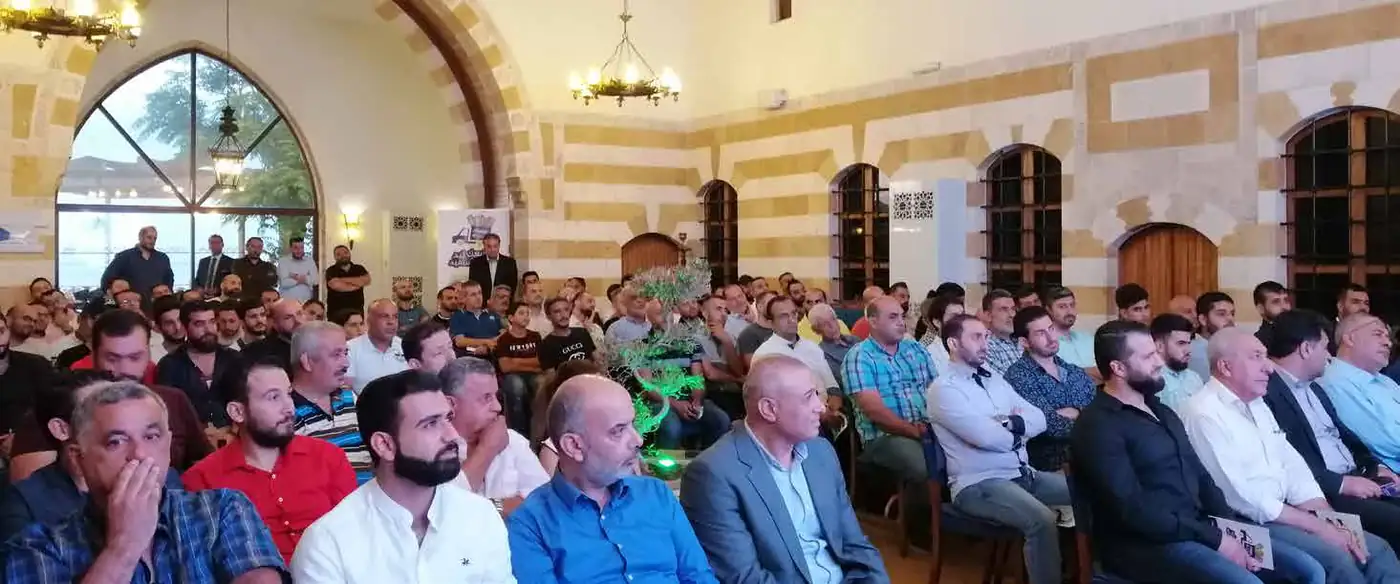Street vendors seated at a sales gathering in a traditional hall