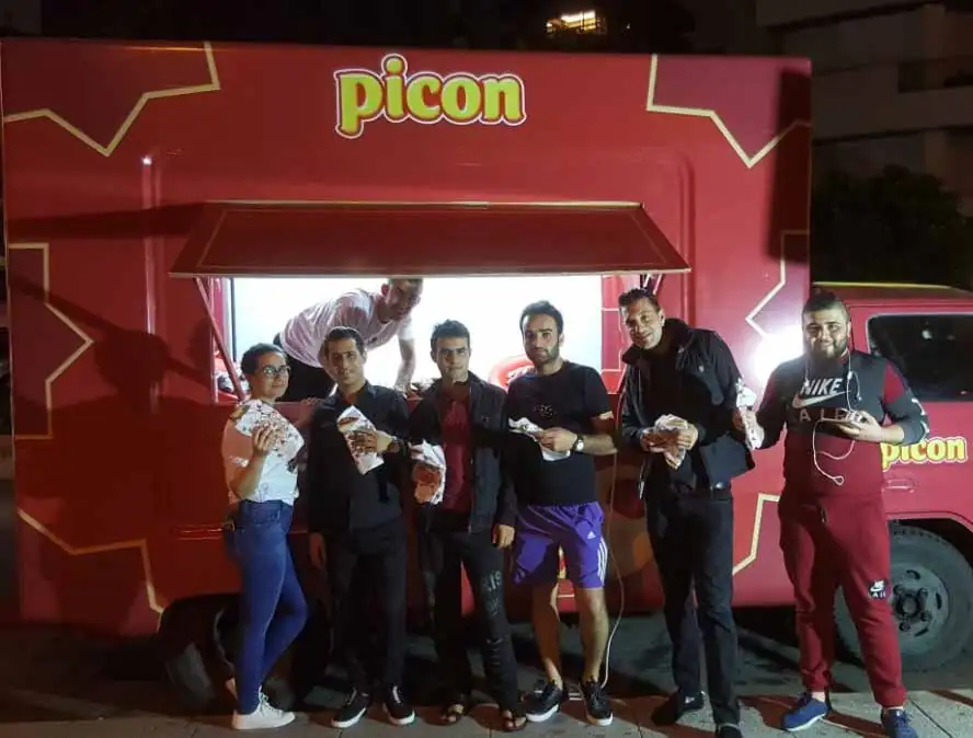 Visitors in front of a Picon food truck at a night-time Ramadan activation